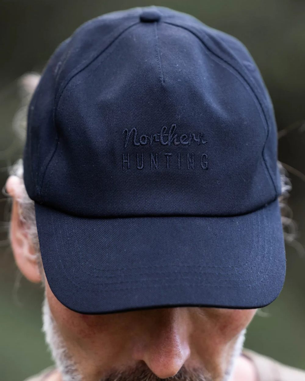 Black coloured Northern Hunting Ravn Water Repellent Cap on blurry background