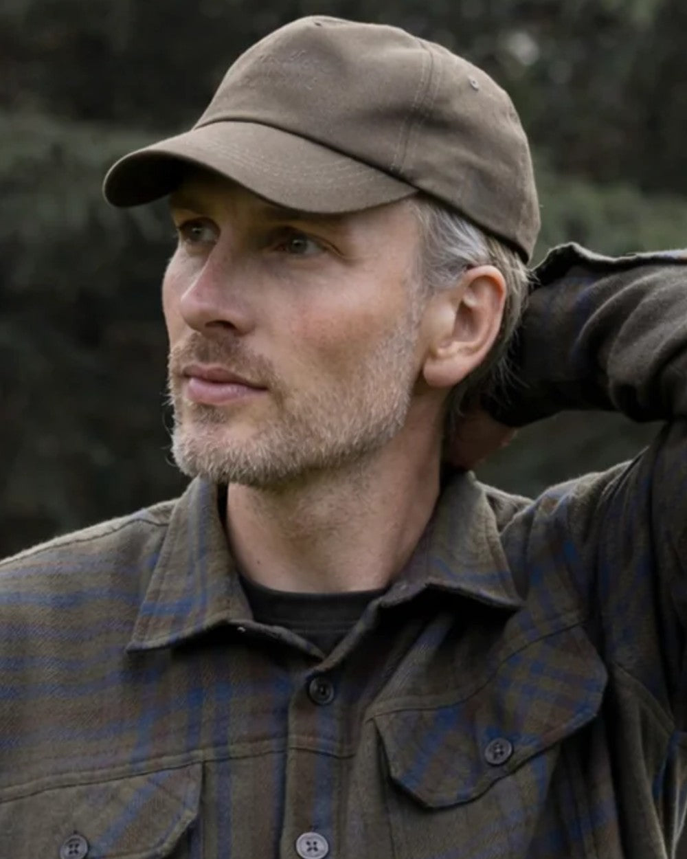 Green coloured Northern Hunting Ravn Water Repellent Cap on blurry background