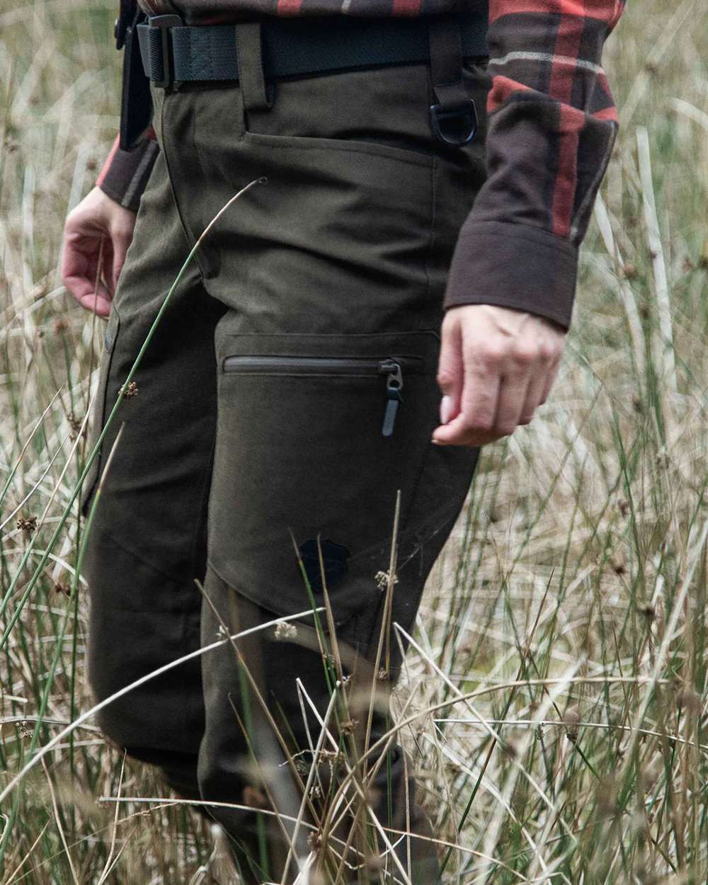 Dark Green coloured Northern Hunting Womens Alva Una G2 Hunting Trousers on forest background