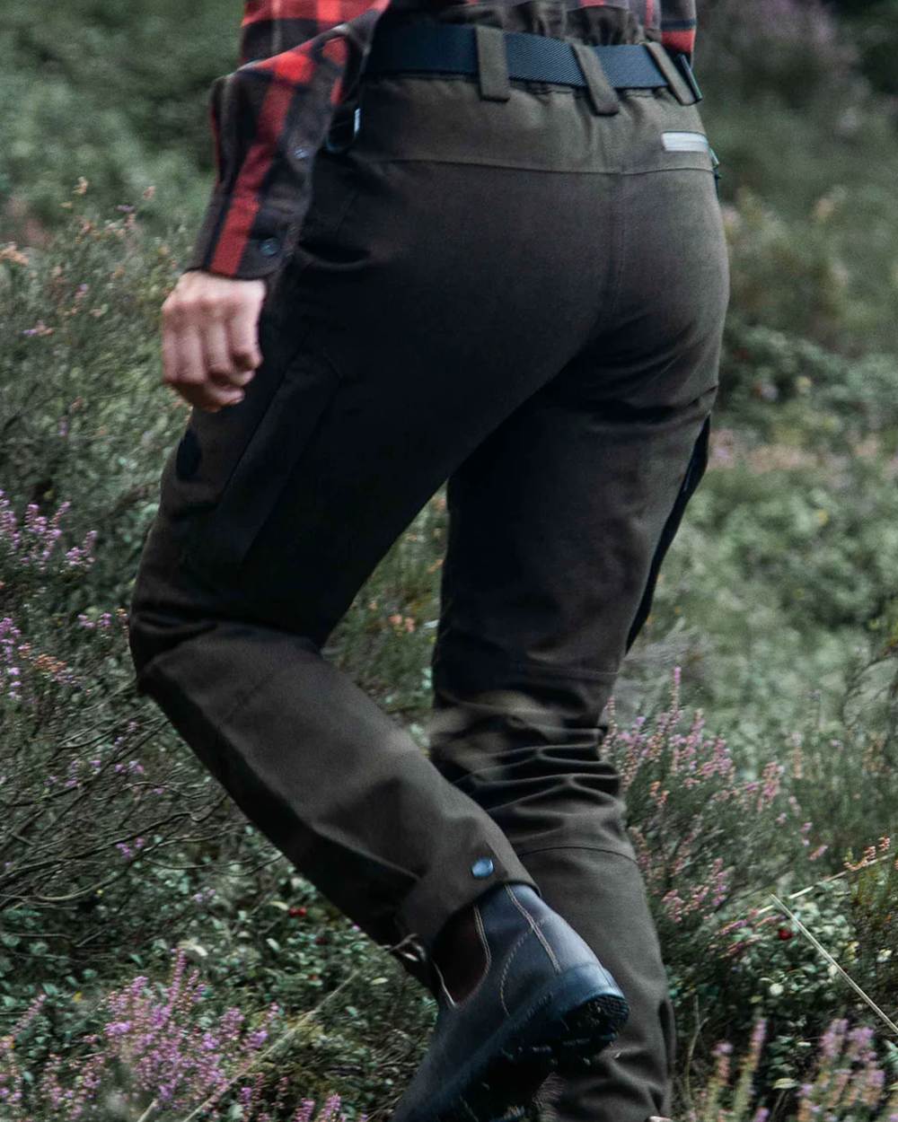 Dark Green coloured Northern Hunting Womens Alva Una G2 Hunting Trousers on forest background