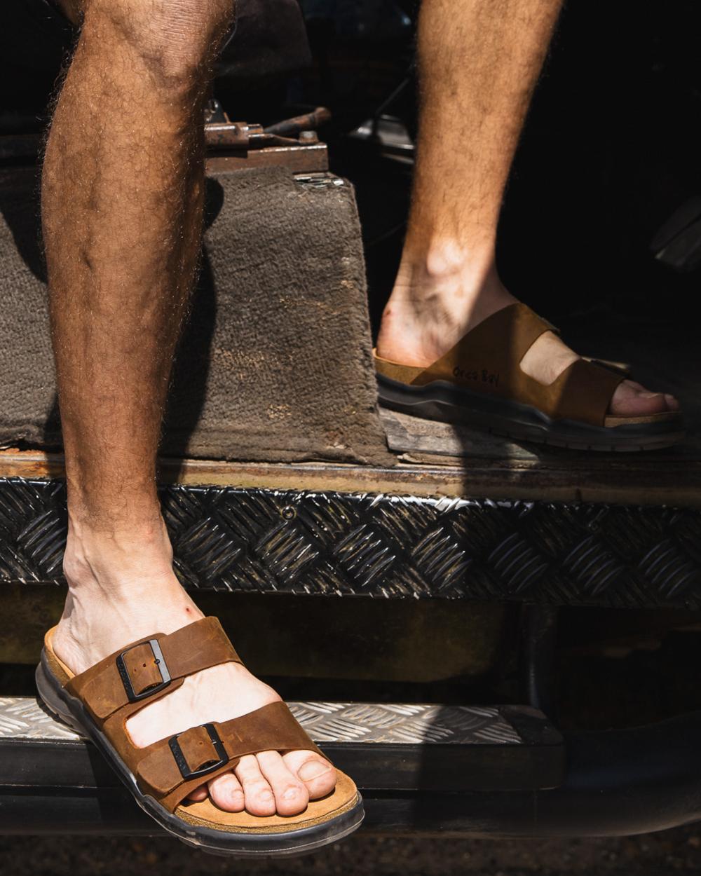 Sand coloured Orca Bay Mens Carbis Sandals on outdoor background