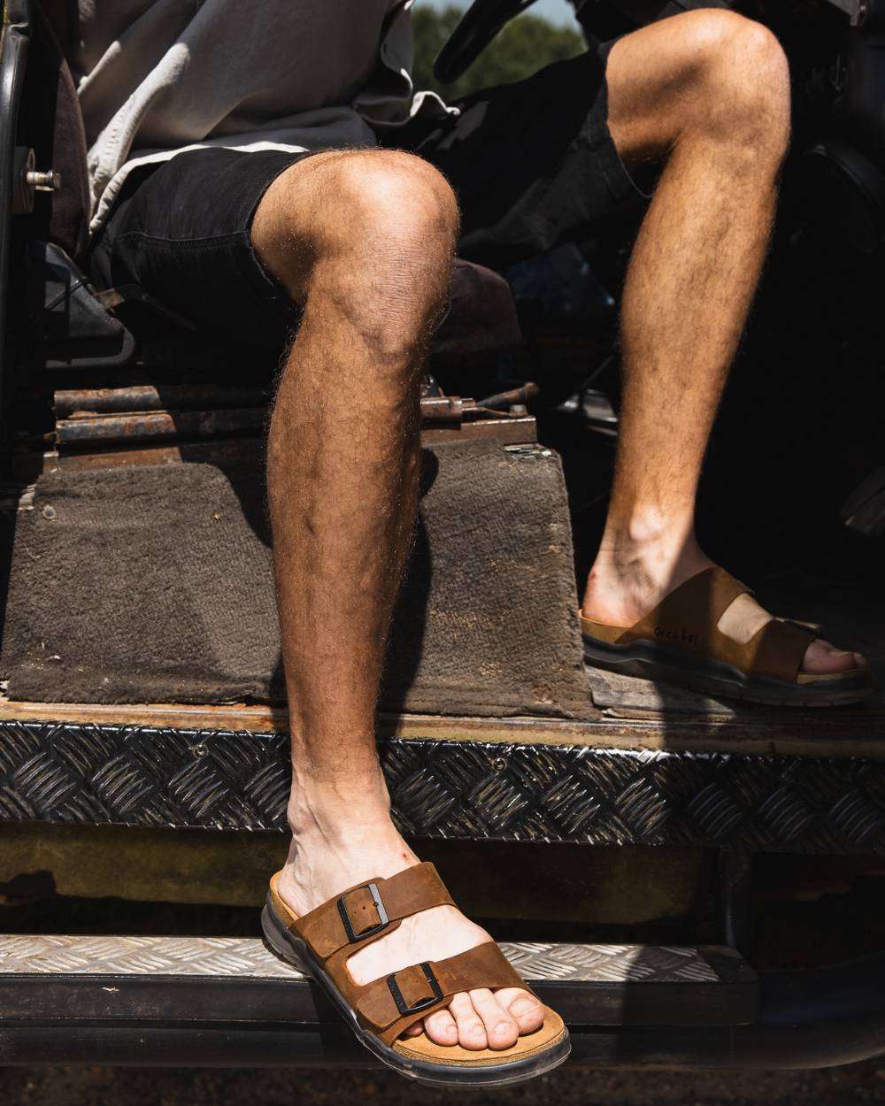 Sand coloured Orca Bay Mens Carbis Sandals on car background