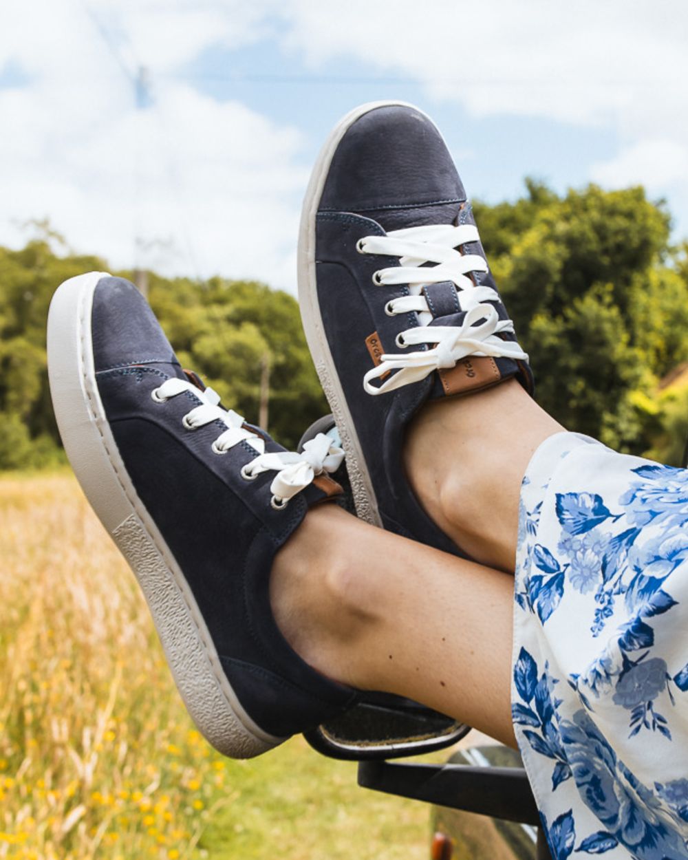 Indigo coloured Orca Bay Womens Mayfair Trainers on grassy background