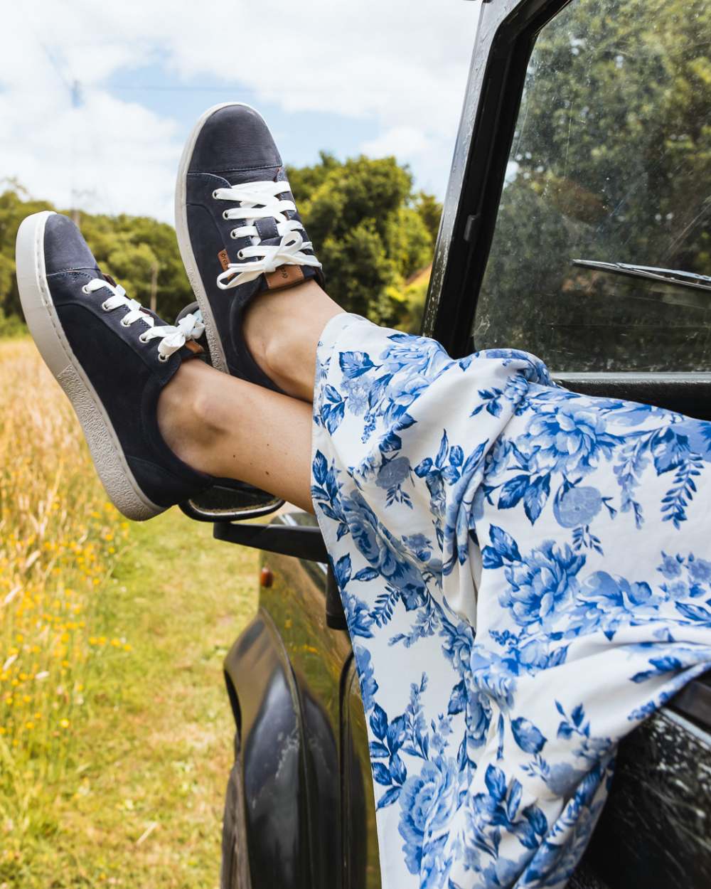 Indigo coloured Orca Bay Womens Mayfair Trainers on grassy background
