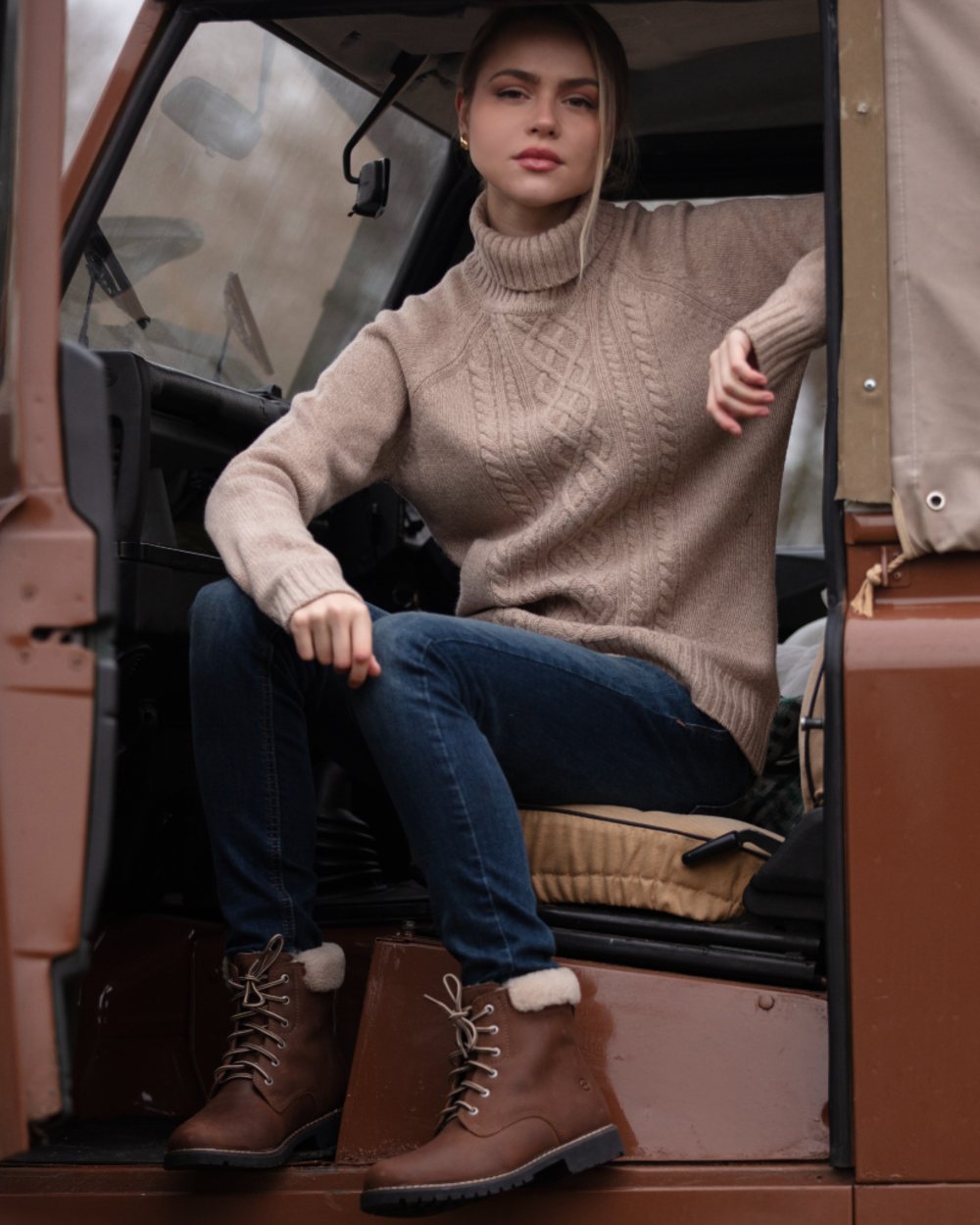 Brown coloured Orca Bay Womens Real Sheepskin Lining Pennine Boots on car background