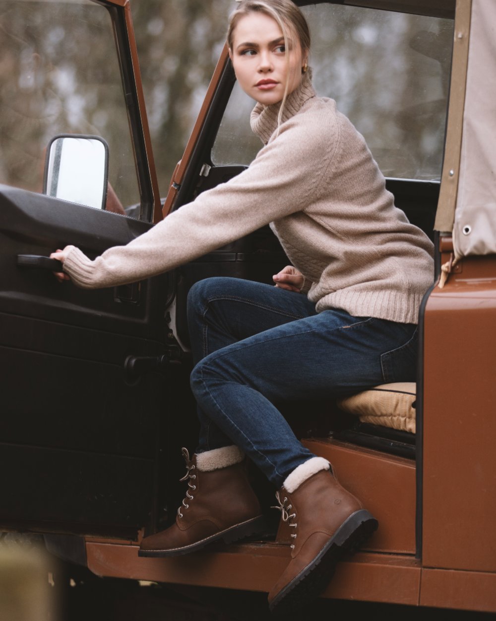 Brown coloured Orca Bay Womens Real Sheepskin Lining Pennine Boots on car background