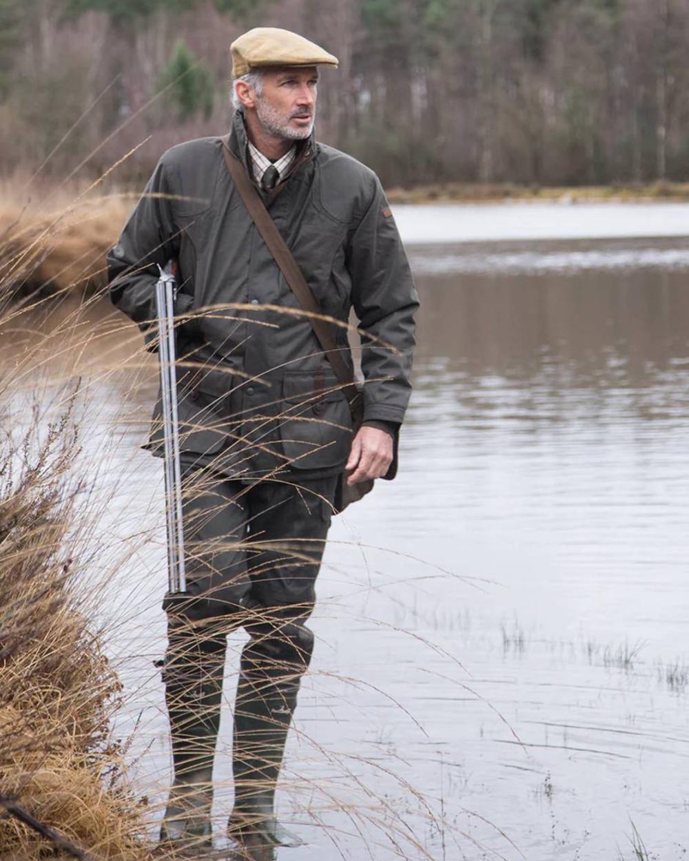 Khaki coloured Percussion Sologne Neoprene Wellington Boots on marshland background