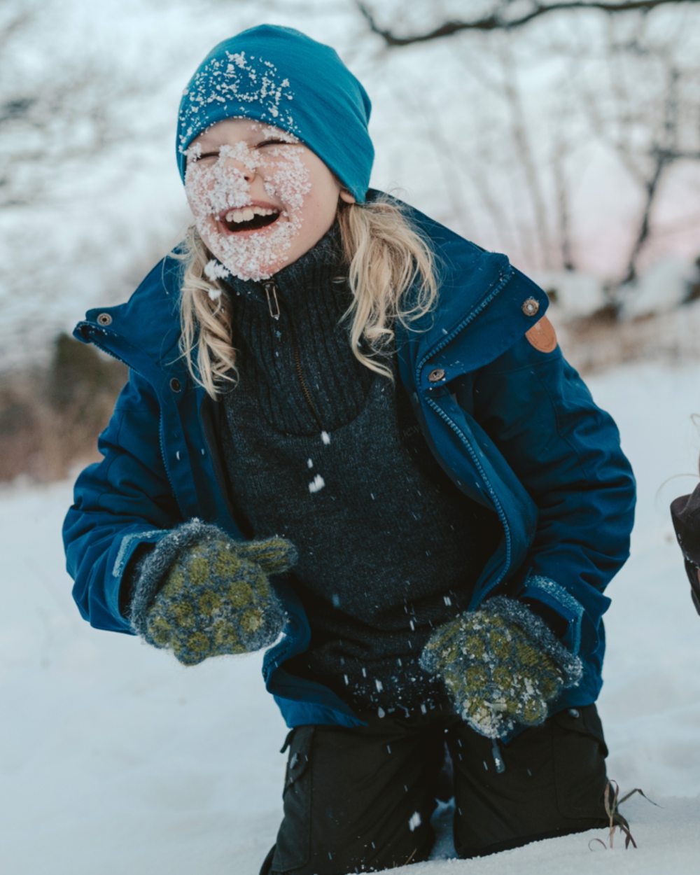Dark Dive coloured Pinewood Childrens Finnveden Hybrid Jacket on snow background