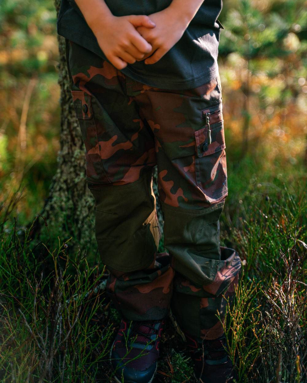Dusty Plum Jungle coloured Pinewood Childrens Lappland Camou Trousers on forest background