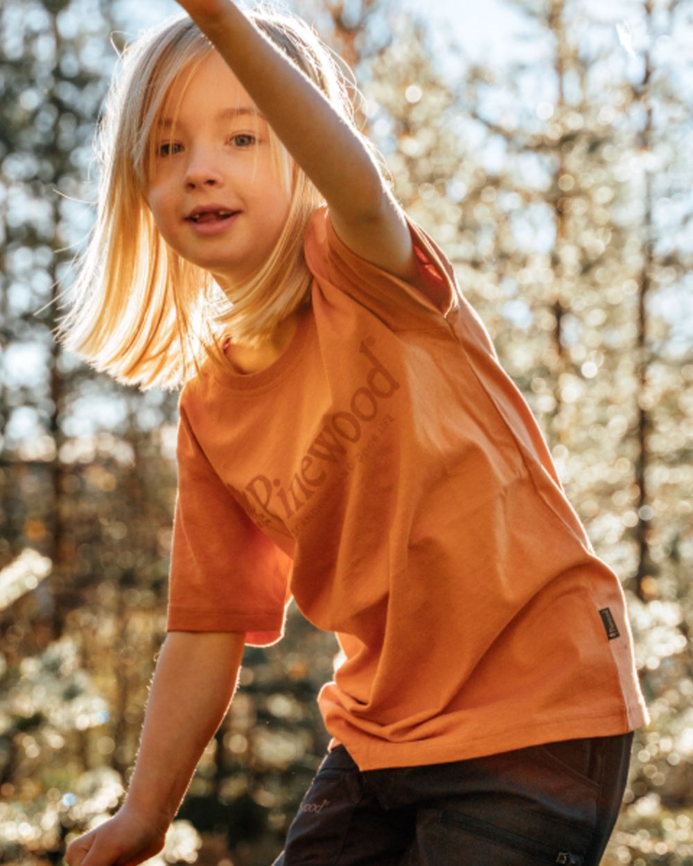Light Terracotta coloured Pinewood Childrens Outdoor Life T-Shirt on forest background