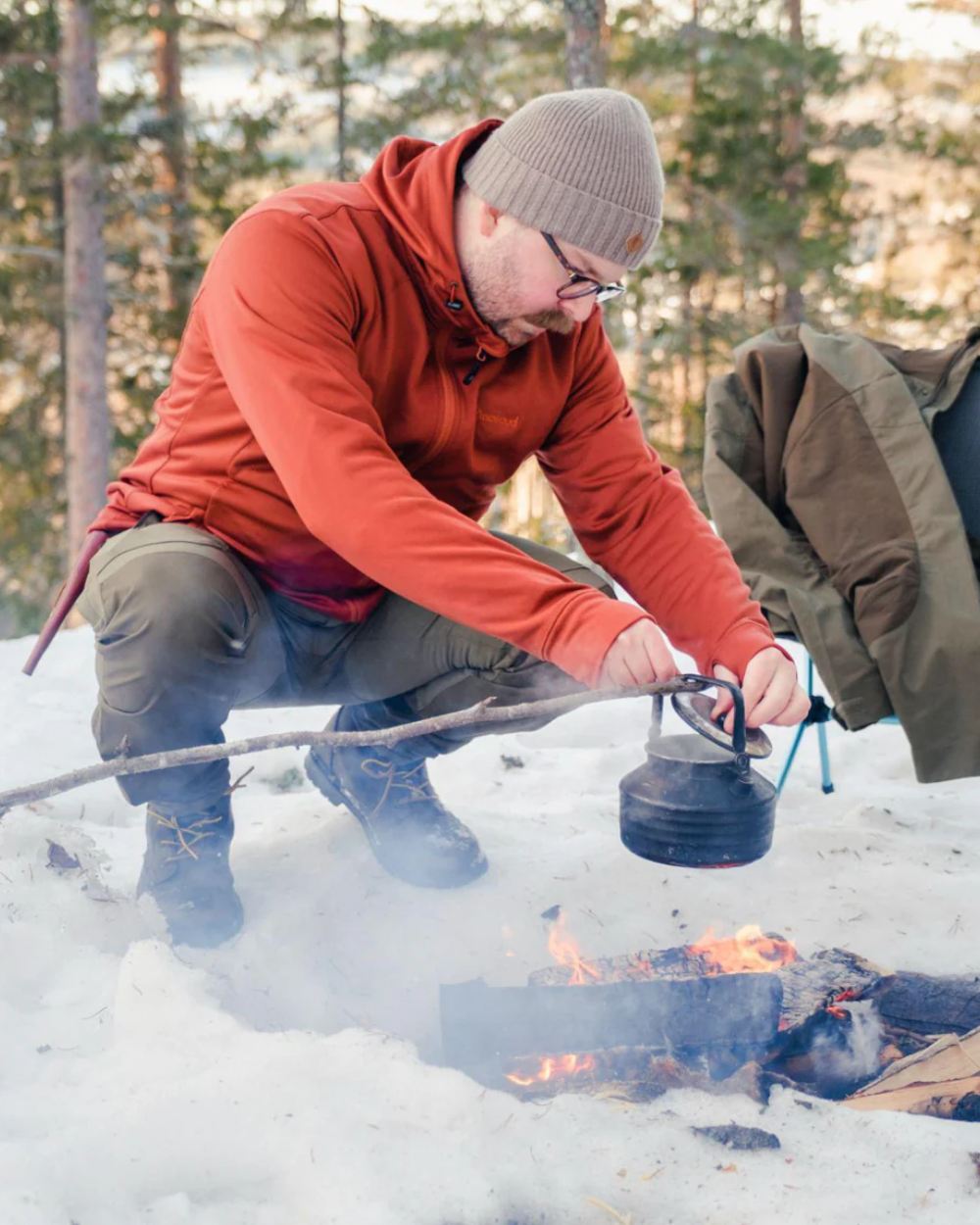 Terracotta coloured Pinewood Finnveden Hoodie on snow background