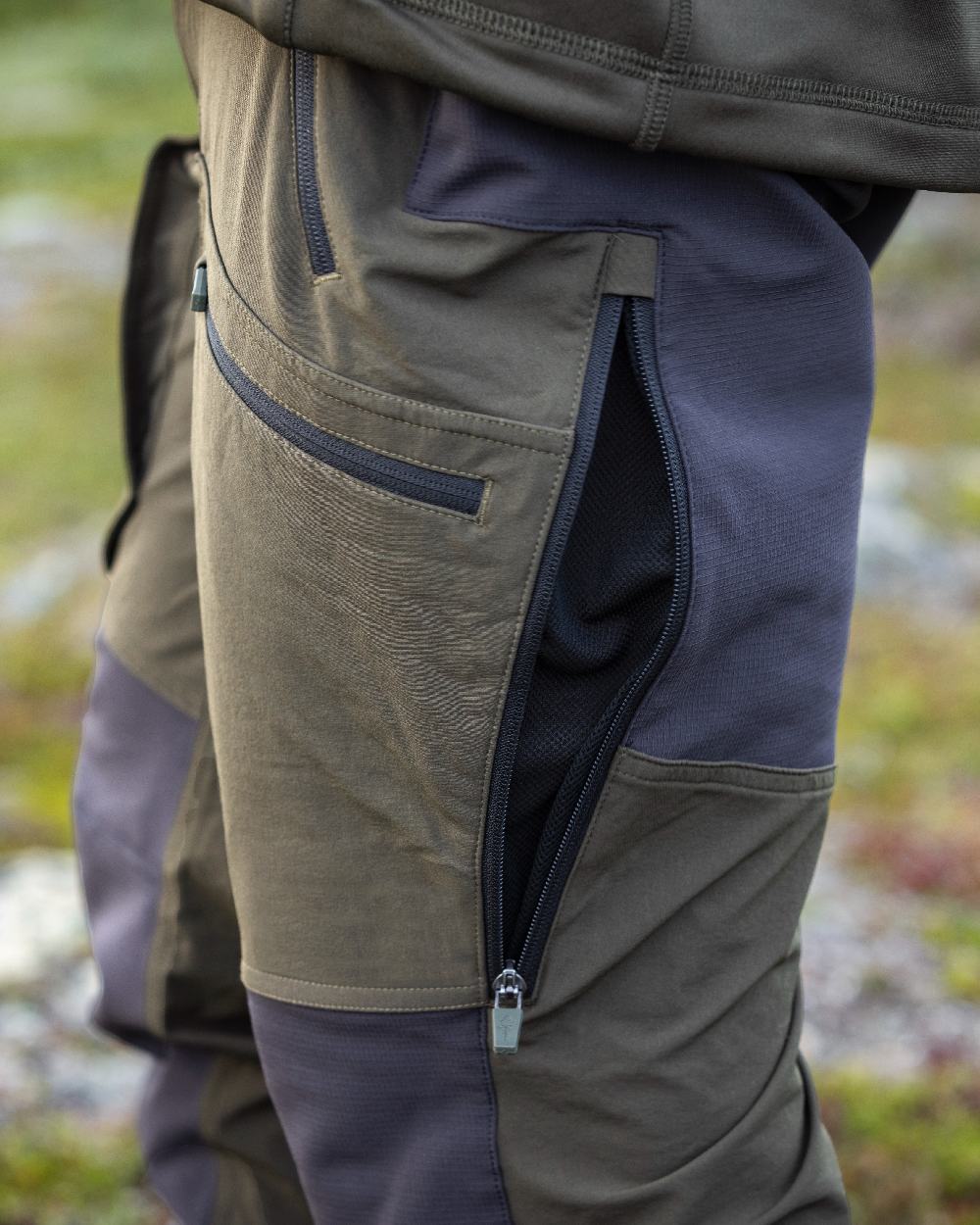 Moss Green Coloured Pinewood Mens Abisko Adventure Trousers on outdoor background