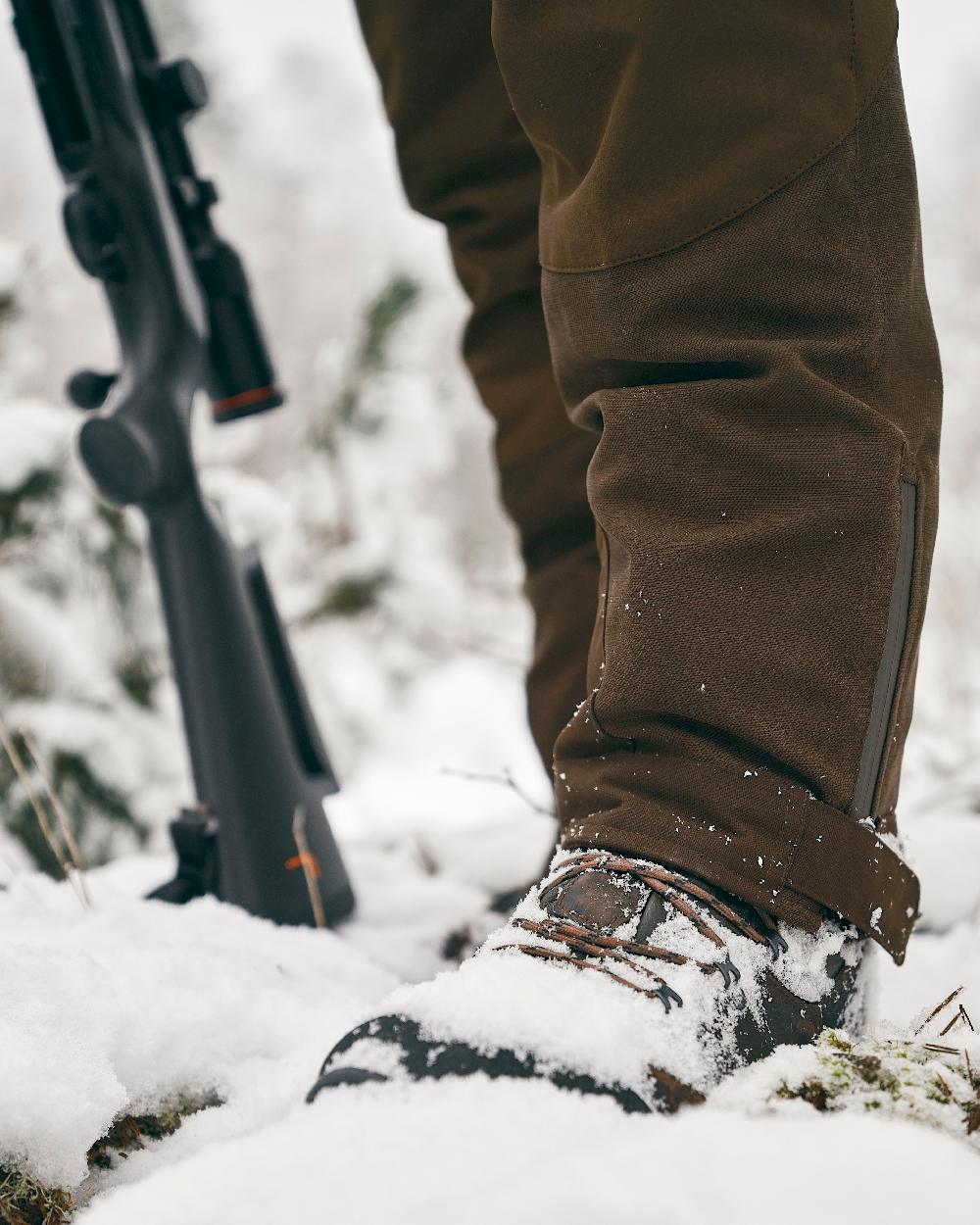 Suede Brown Dark Olive Coloured Pinewood Mens Caribou Hunt Extreme Trousers on snow background