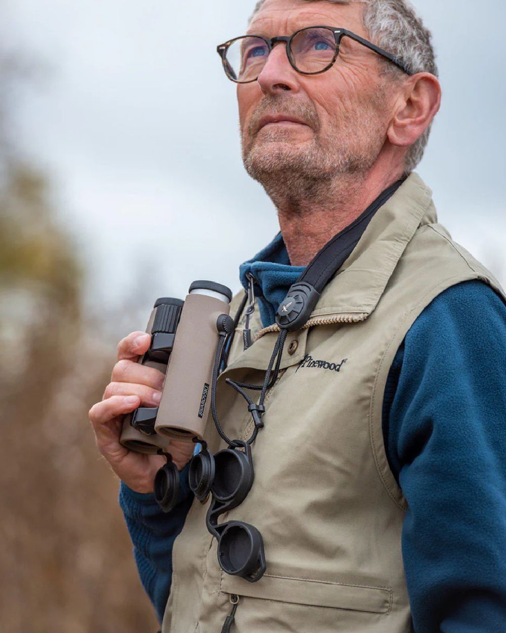 Light Khaki coloured Pinewood Mens Tiveden Vest on blurry background