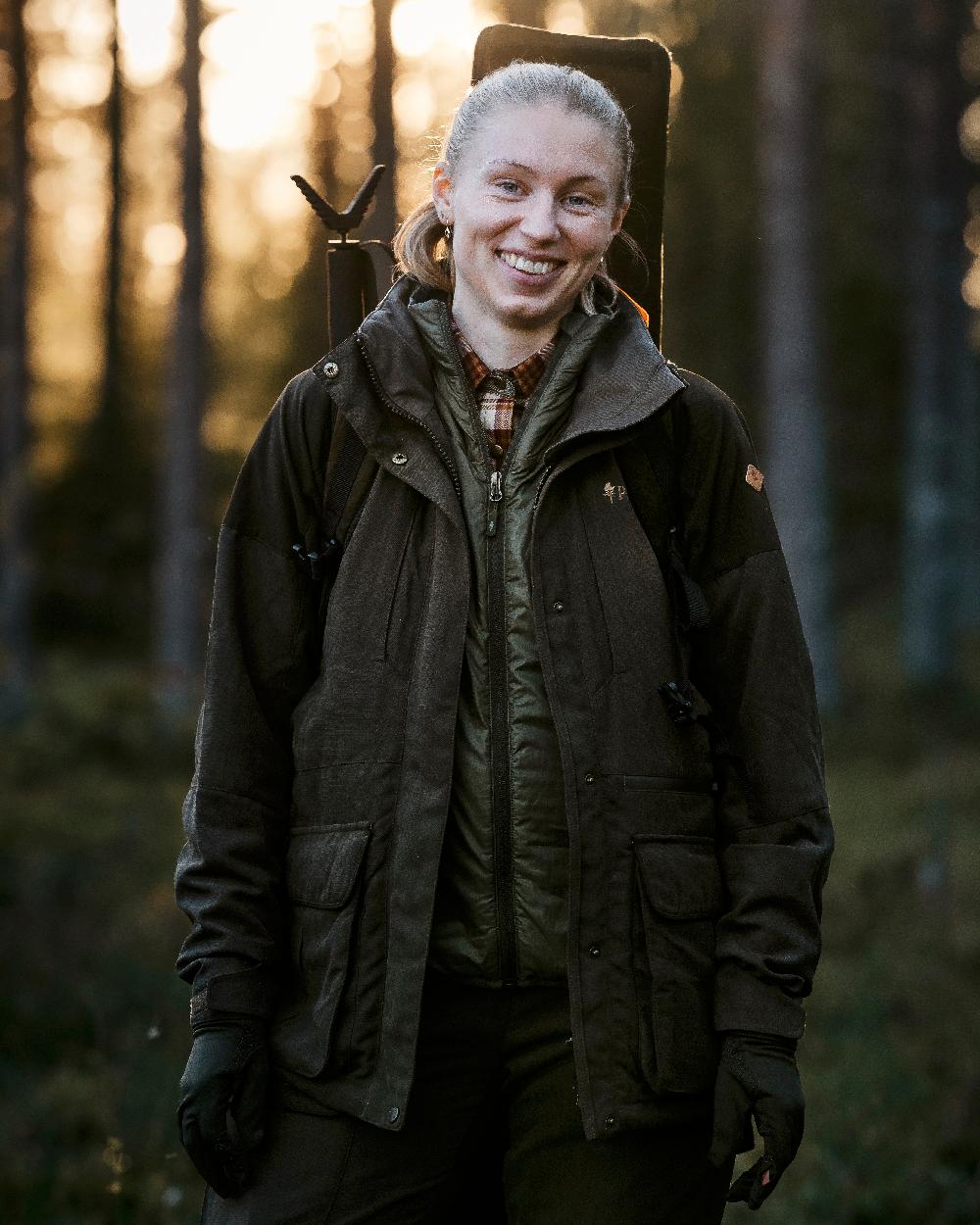 Moss Green Coloured Pinewood Thin Liner Gloves on outdoor background