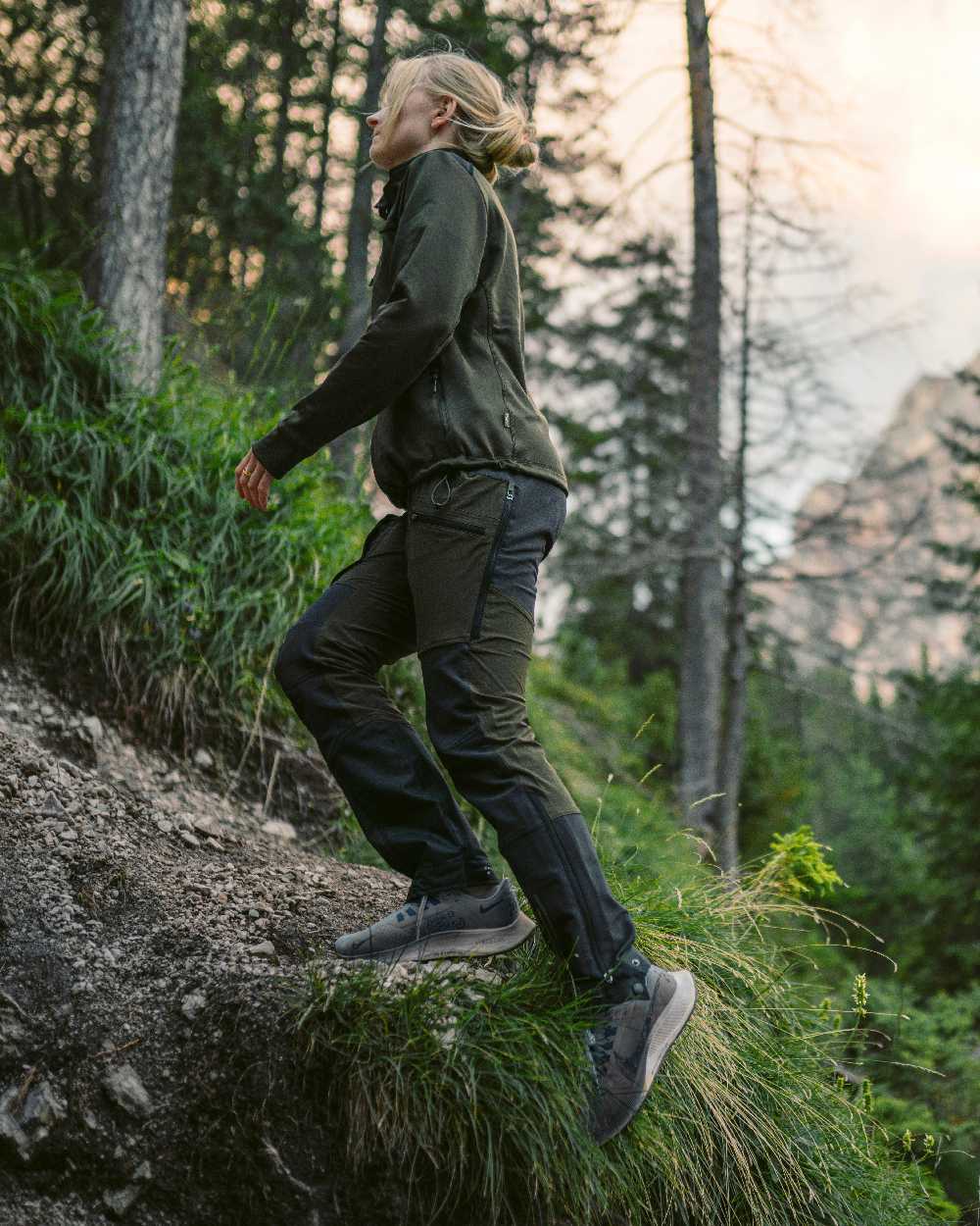 Moss Green Coloured Pinewood Womens Abisko Adventure Trousers on mountain background