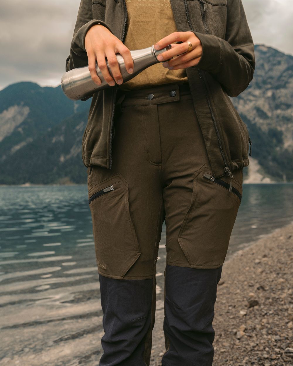 Moss Green Coloured Pinewood Womens Abisko Adventure Trousers on mountain background