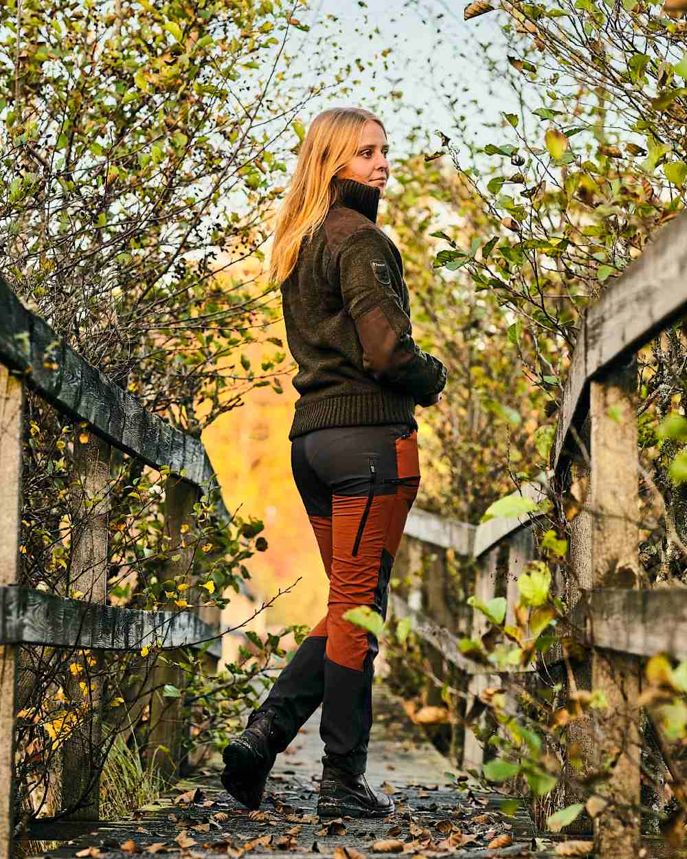 Terracotta Dark Anthracite Coloured Pinewood Womens Abisko Brenton Trousers on forest background