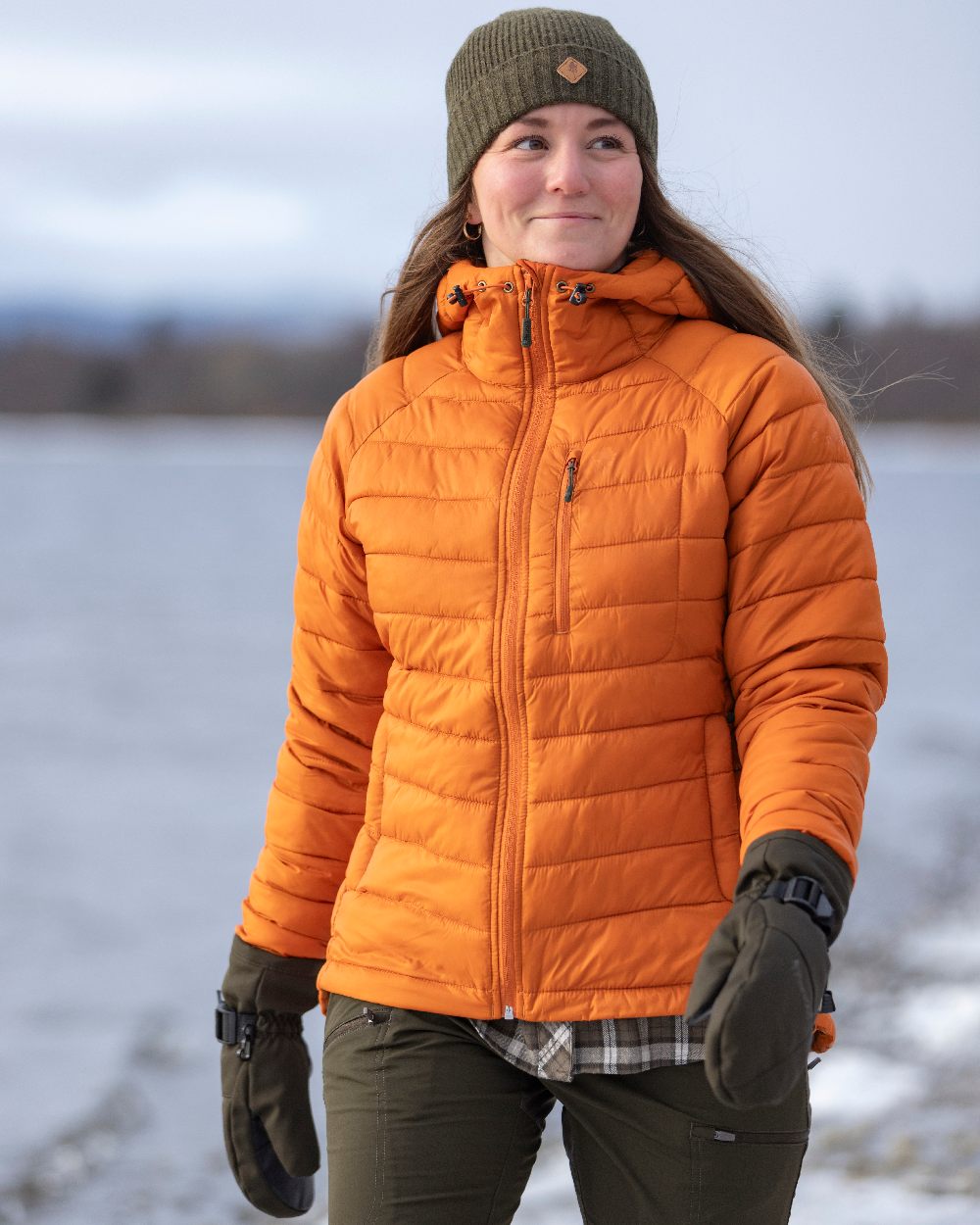Burned Orange Coloured Pinewood Womens Abisko Insulation Jacket on snow background