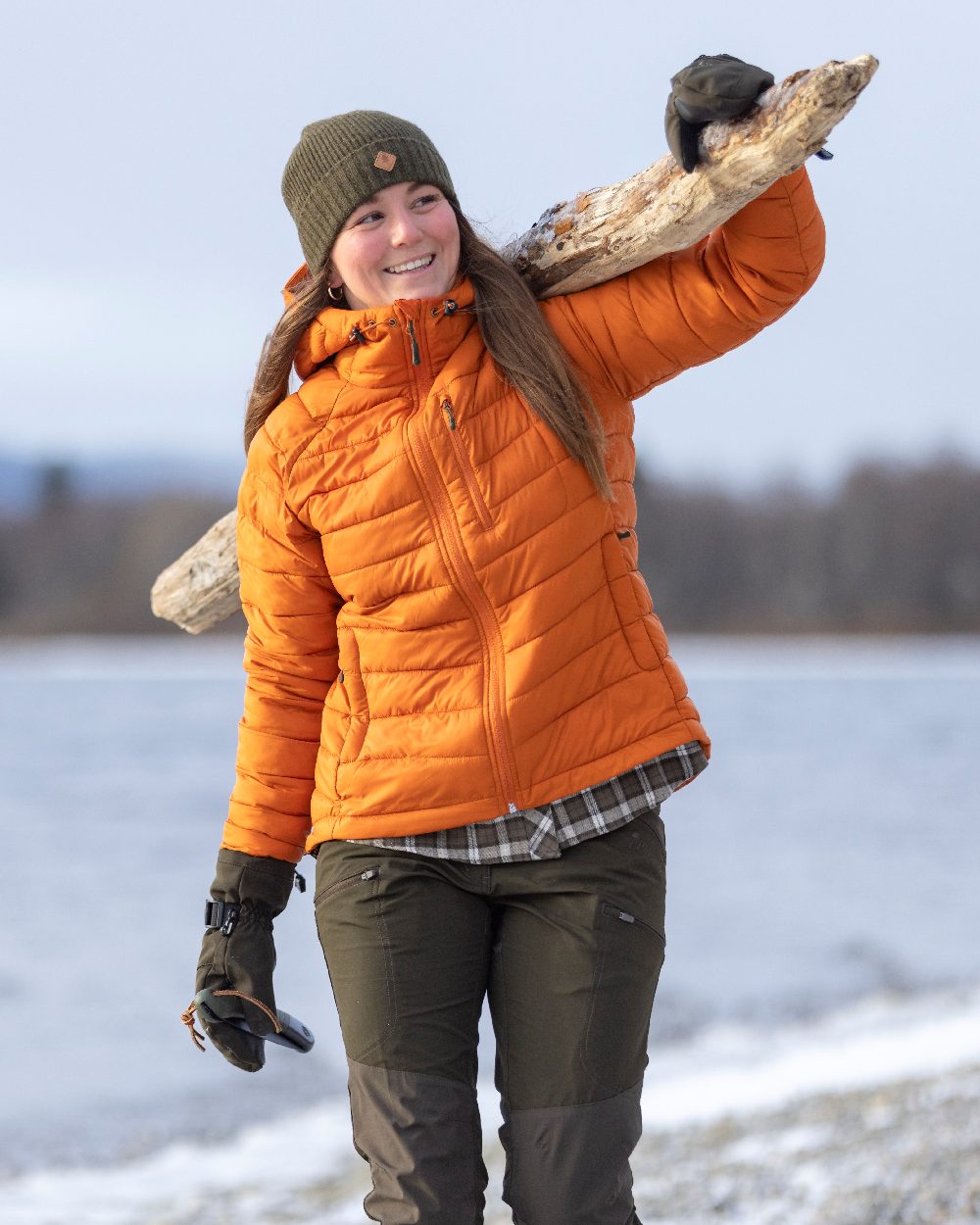 Burned Orange Coloured Pinewood Womens Abisko Insulation Jacket on snow background