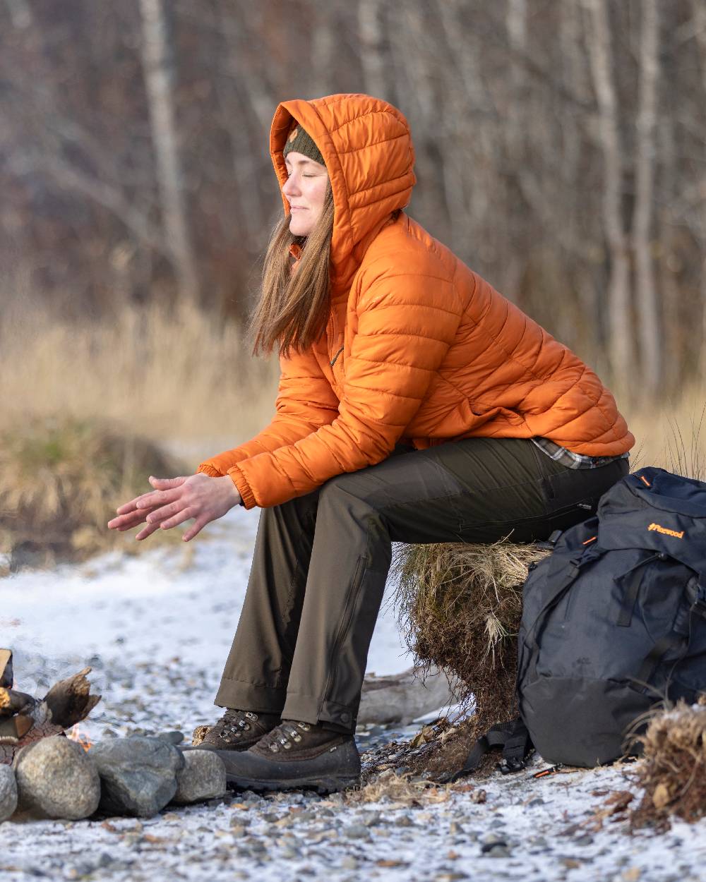 Burned Orange Coloured Pinewood Womens Abisko Insulation Jacket on snow background
