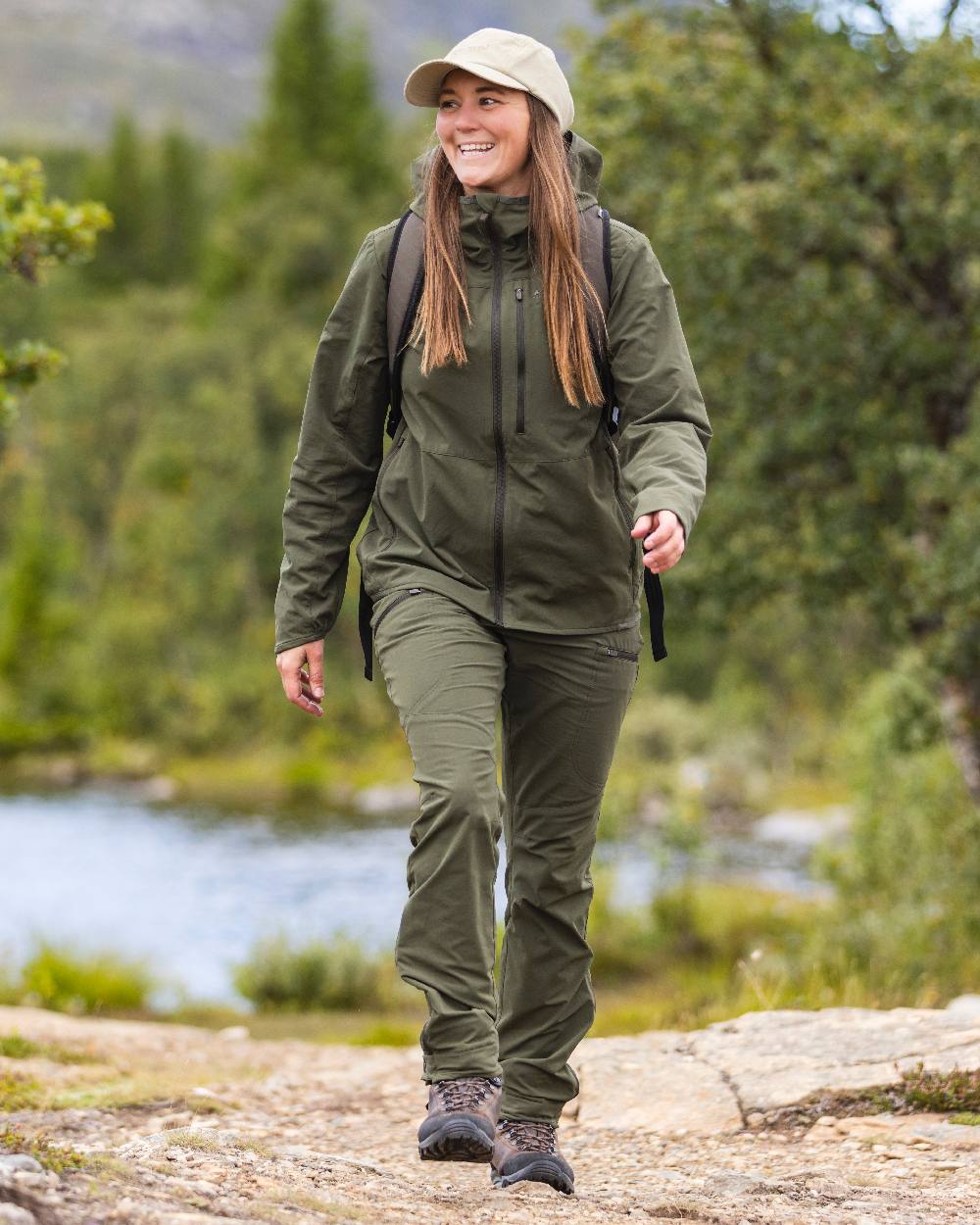 Mossgreen Coloured Pinewood Womens Abisko Light Stretch Trousers on outdoor background