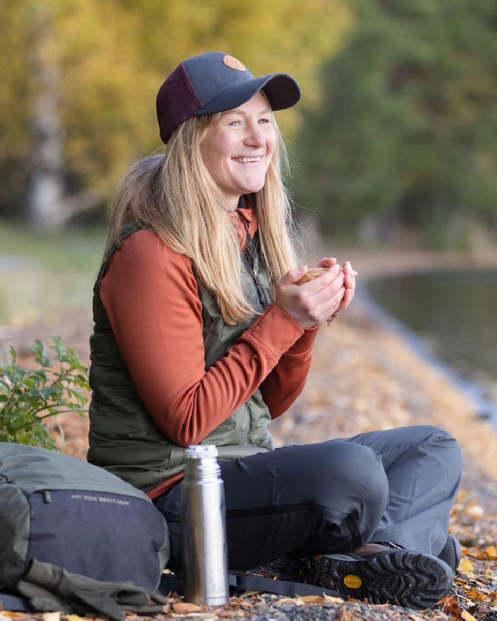 Terracotta coloured Pinewood Womens Finnveden Hoodie on lake background