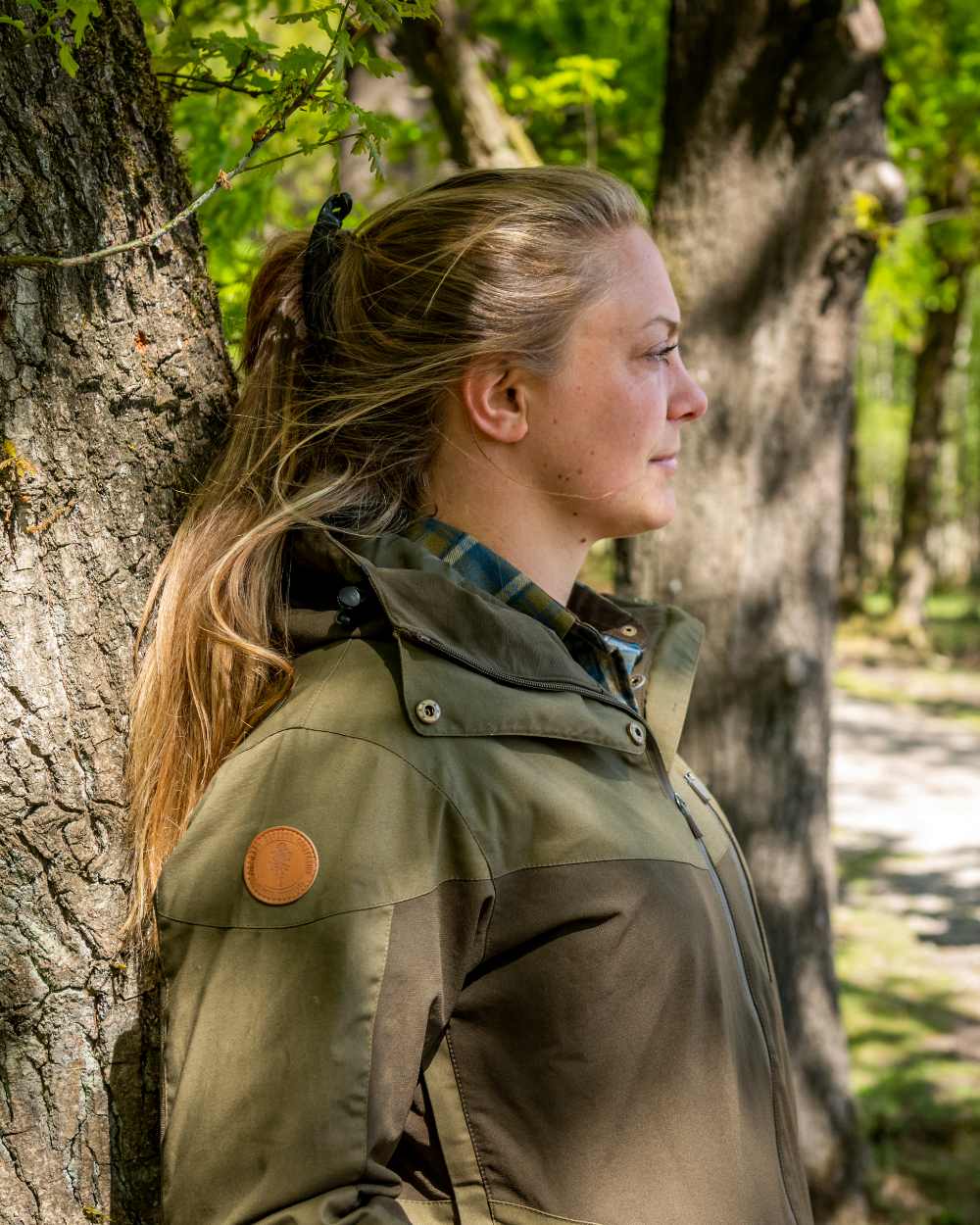 Dark Olive Hunting Olive Coloured Pinewood Womens Finnveden Hybrid Extreme Jacket on outdoor background