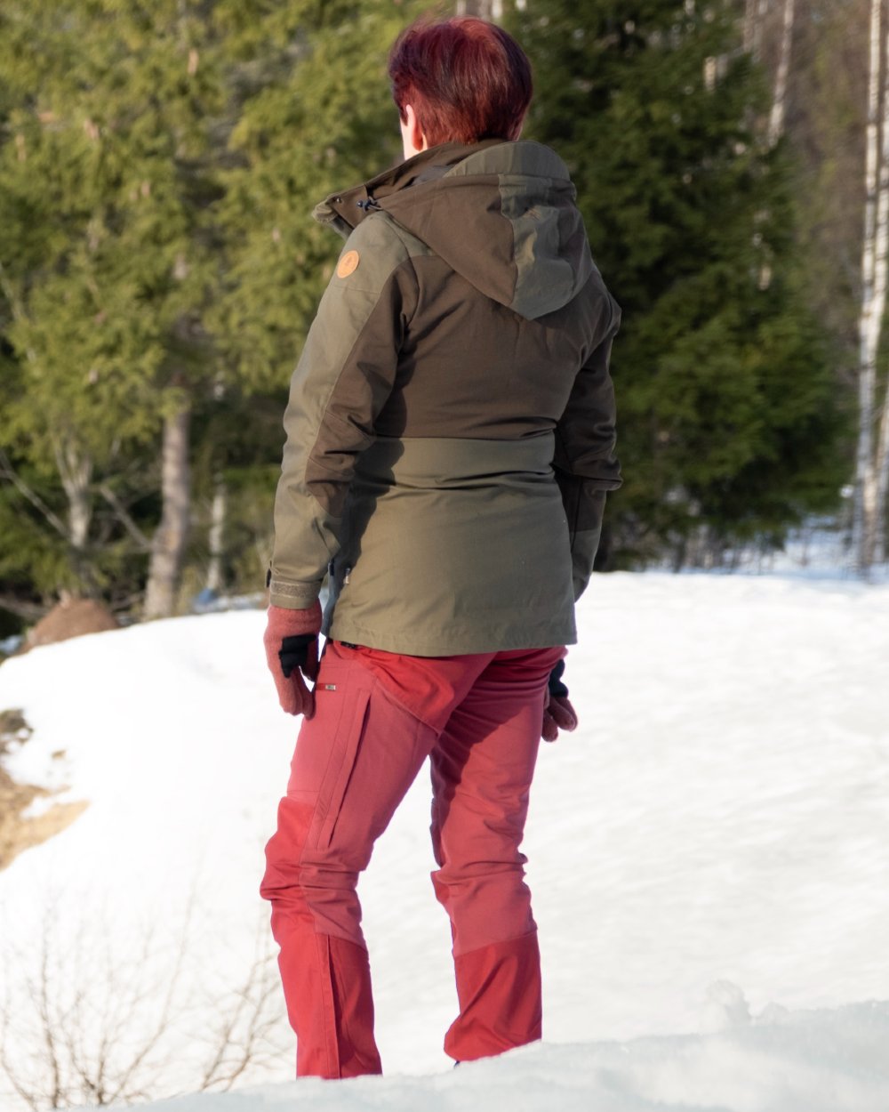 Dark Olive Hunting Olive coloured Pinewood Womens Finnveden Hybrid Jacket on snow background