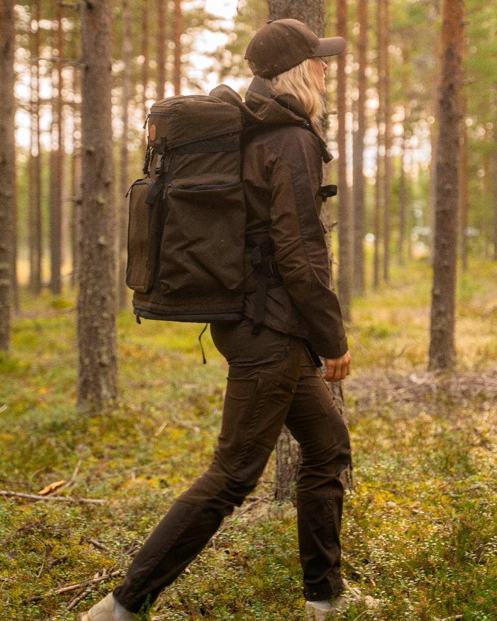 Dark Brown Coloured Pinewood Womens Finnveden Hybrid Trousers on outdoor background