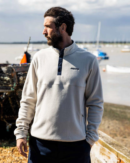 Pumice Coloured Musto Mens Classic Fleece Pullover On A Beach Background 