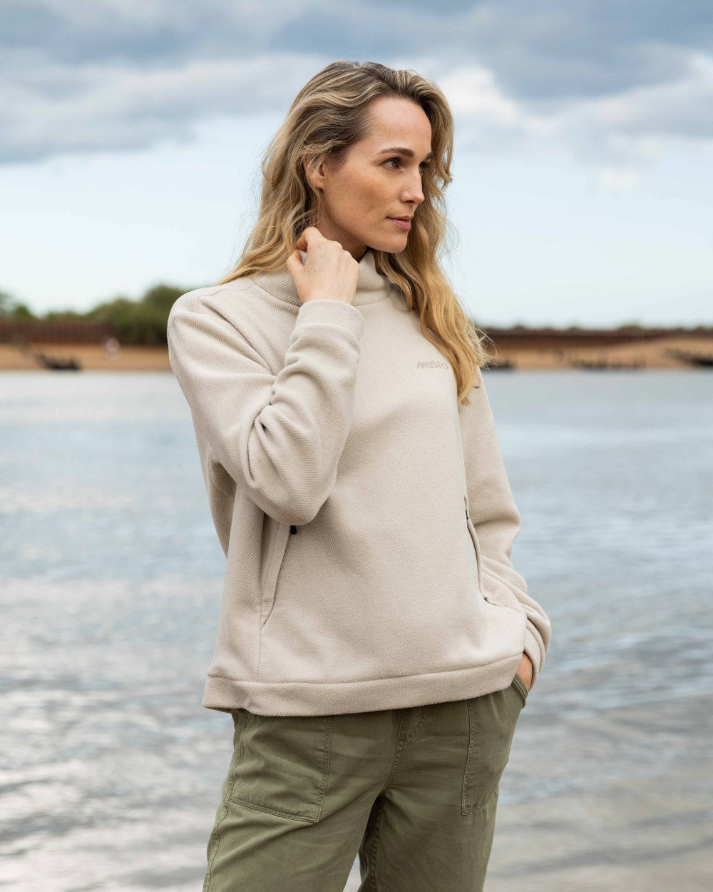 Pumice Coloured Musto Womens Classic Fleece Pullover On A Beach Background 