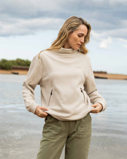 Pumice Coloured Musto Womens Classic Fleece Pullover On A Beach Background 