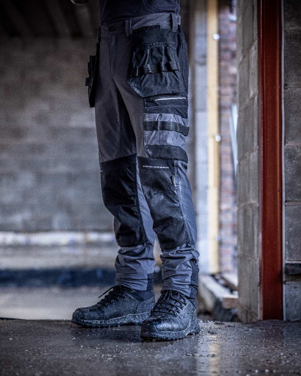 Slate Grey Black coloured Regatta Mens 4Tex Stretch Holster Trousers on wall background