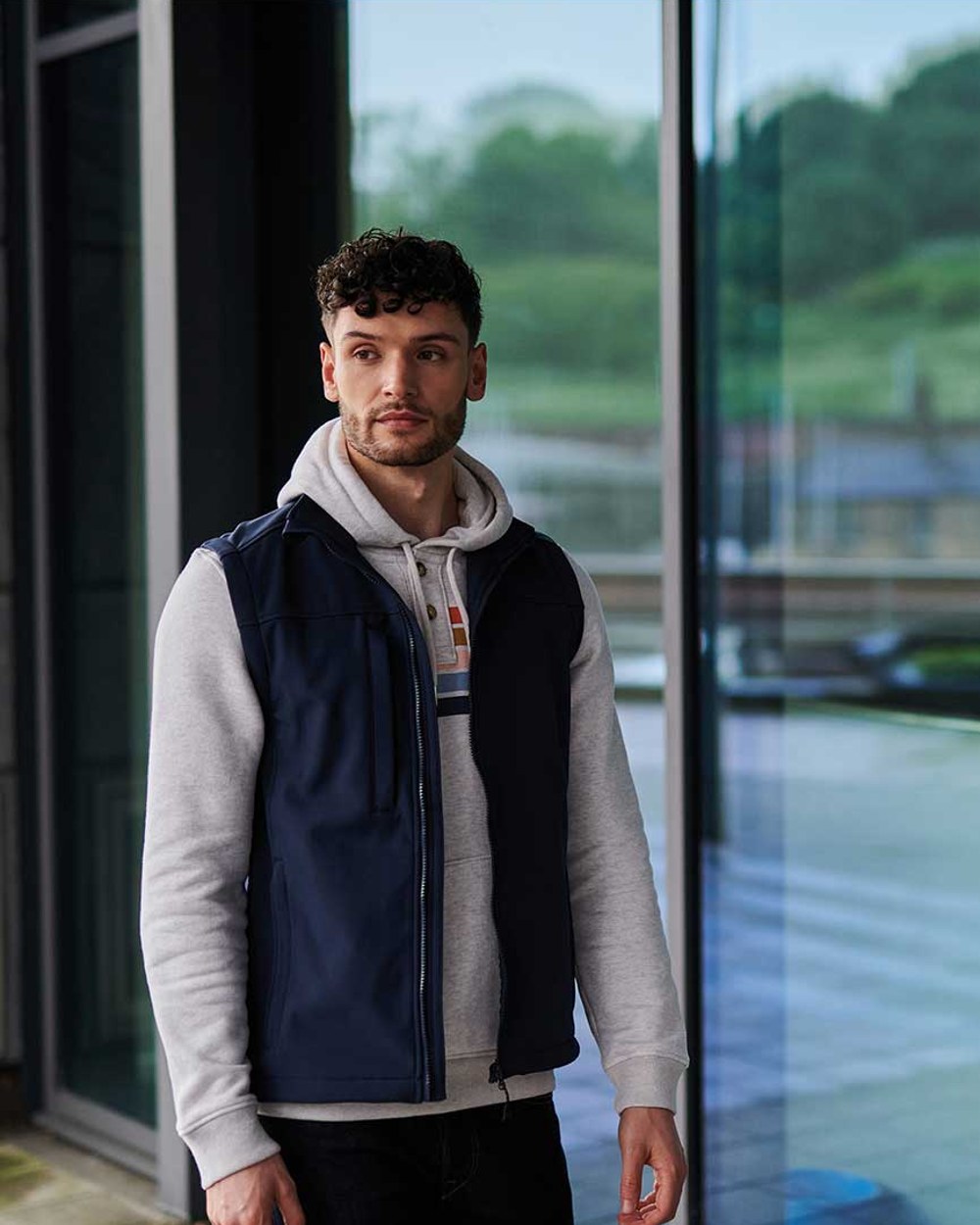 Navy coloured Regatta Mens Flux Softshell Bodywarmer on window background