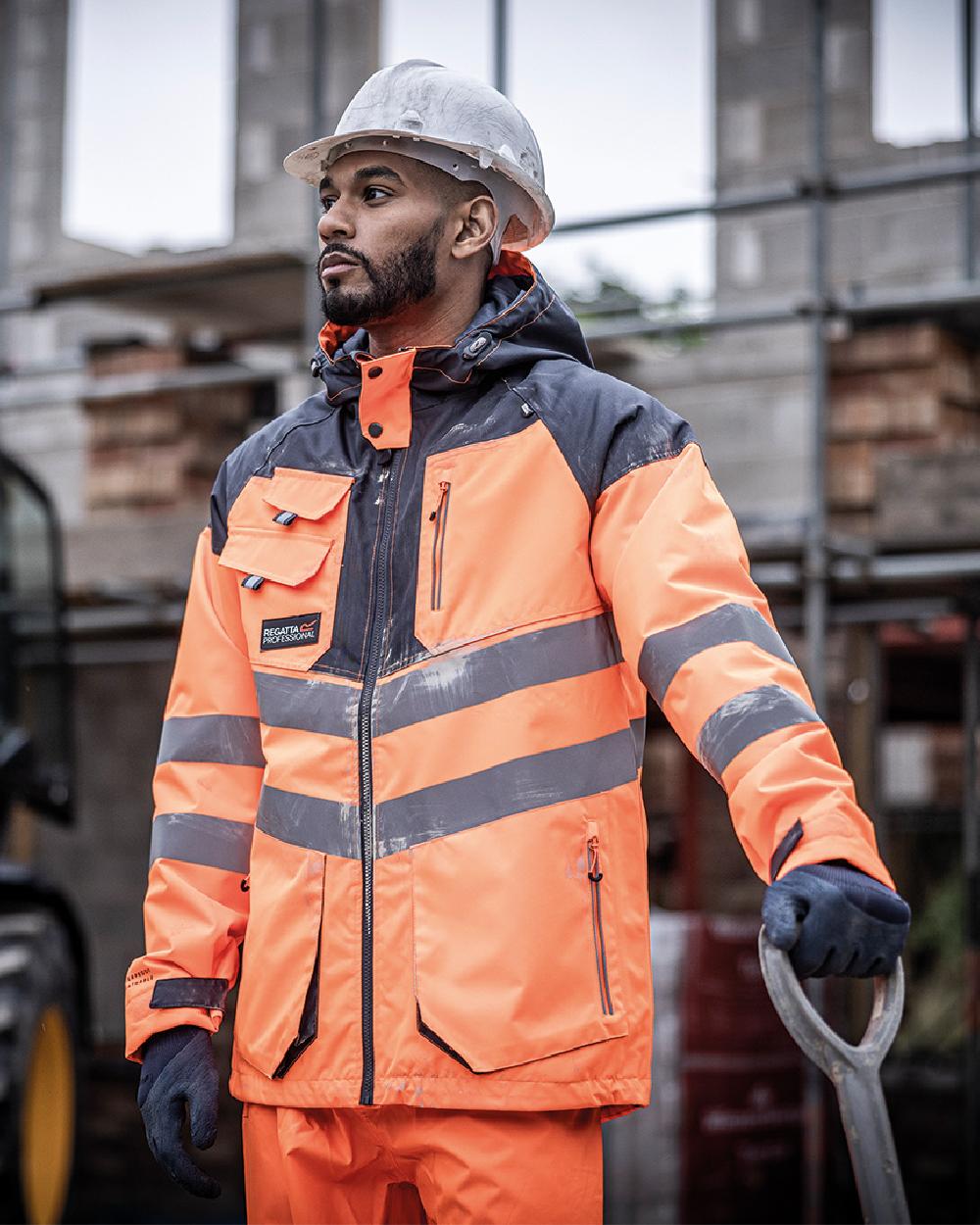 Orange Grey coloured Regatta Mens Hi-Vis Waterproof Reflective Parka Jacket on blurry background