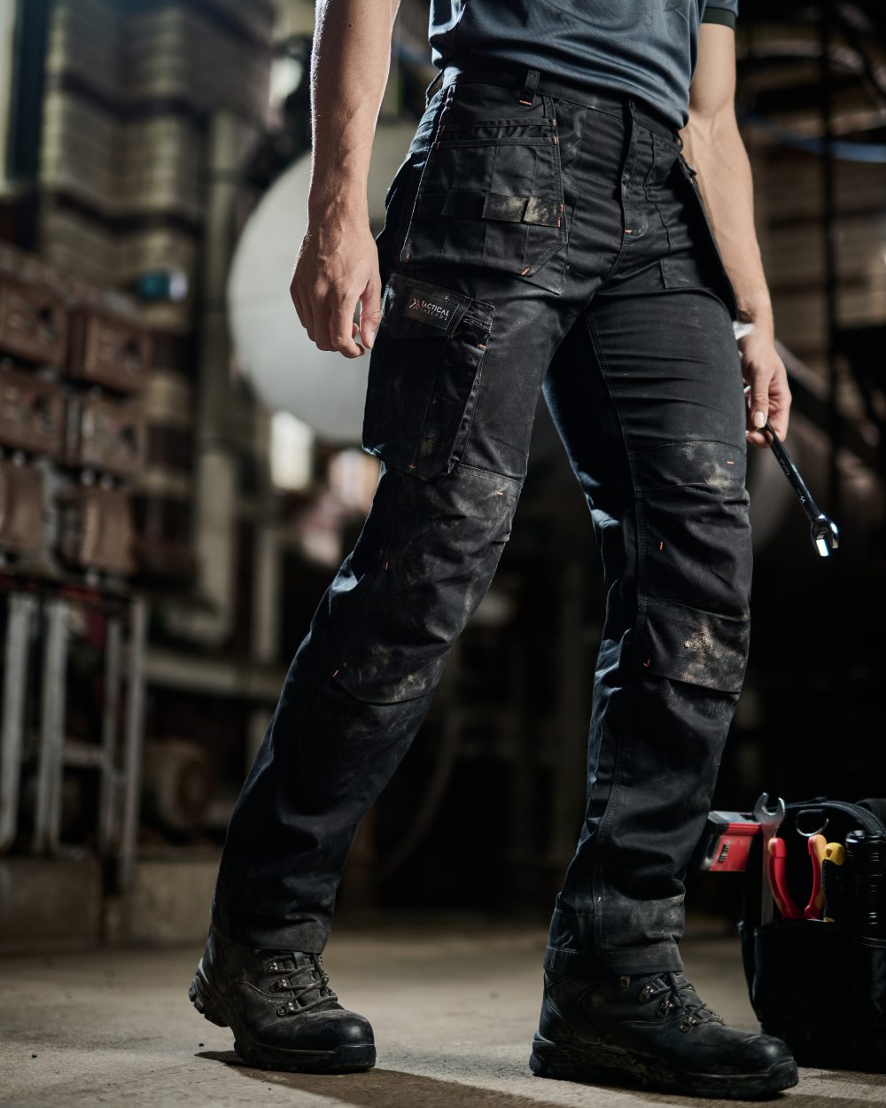 Black coloured Regatta Mens Incursion Work Trousers on blurry background