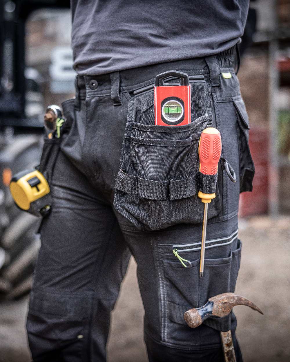 Black coloured Regatta Mens Infiltrate Softshell Stretch Trousers on blurry background