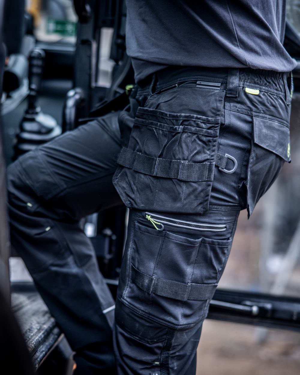Black coloured Regatta Mens Infiltrate Softshell Stretch Trousers on blurry background