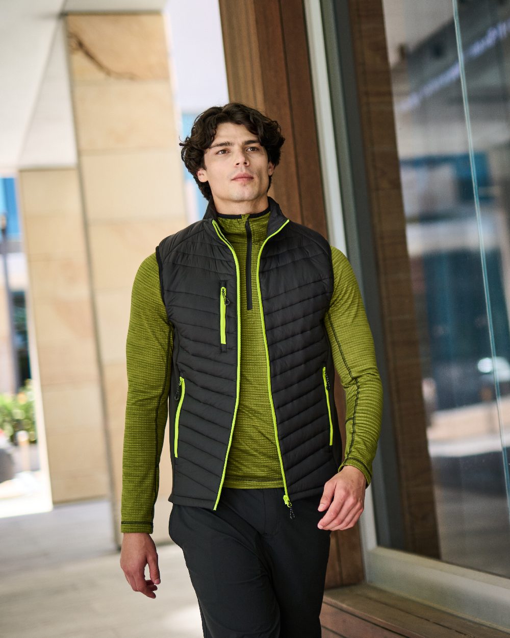Black Lime Green coloured Regatta Mens Navigate Hybrid Bodywarmer on blurry background