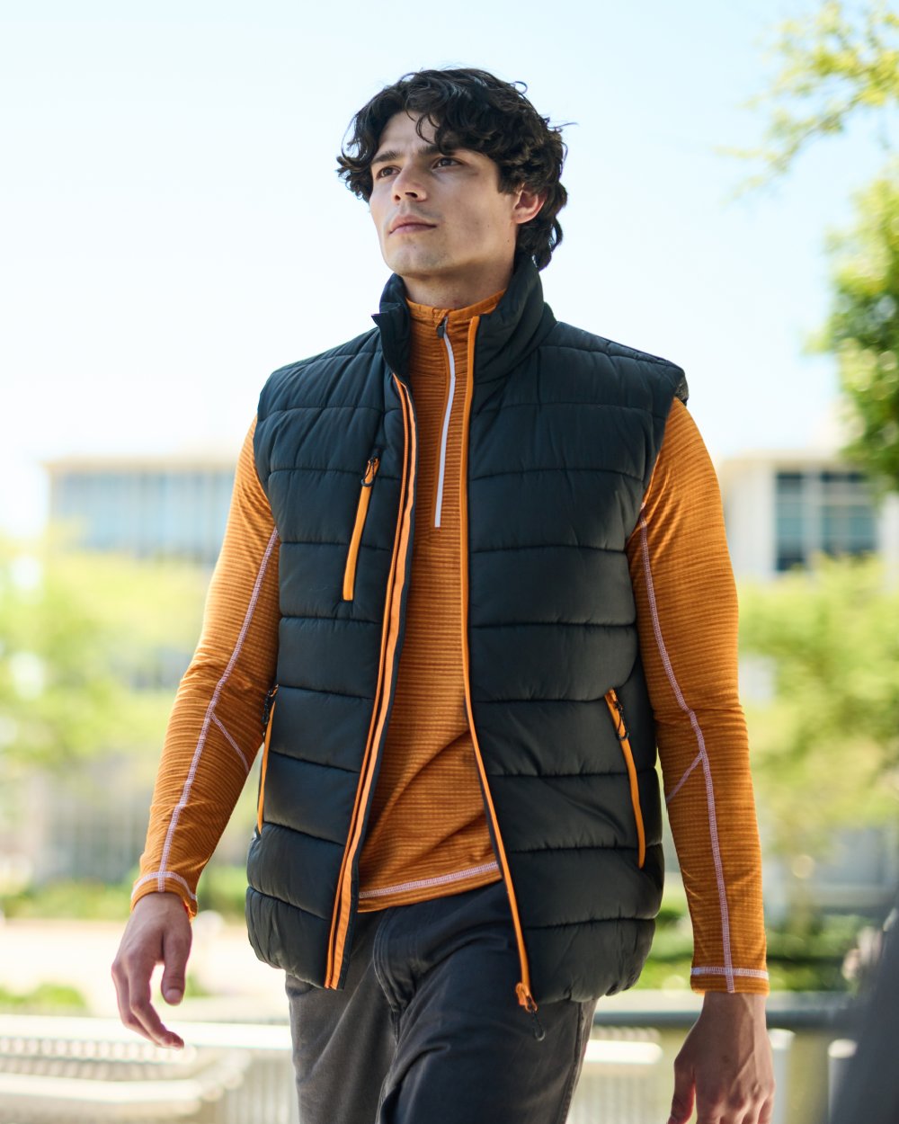 Black Orange Pop coloured Regatta Mens Navigate Thermal Bodywarmer on blurry background