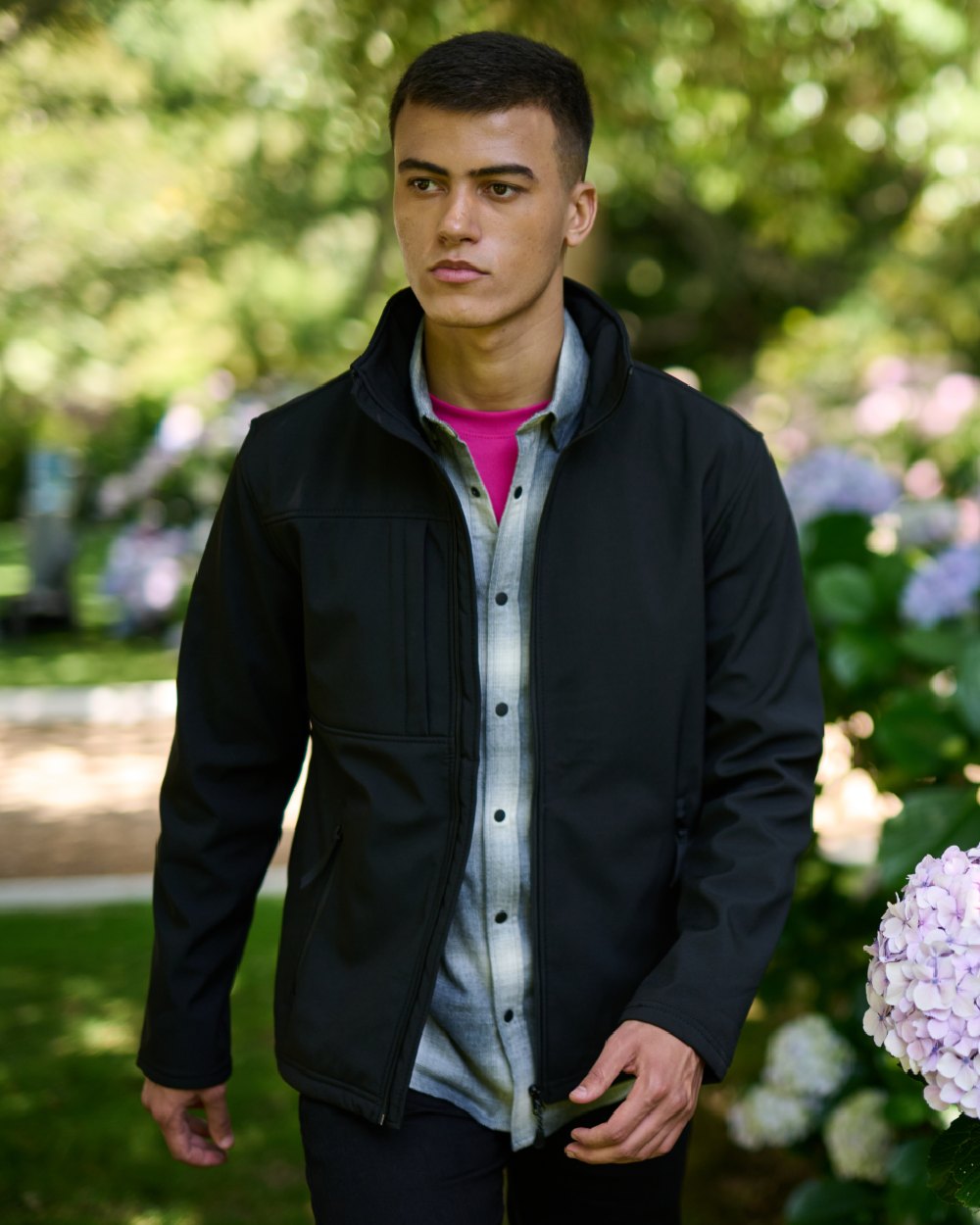 Black coloured Regatta Mens Octagon II Printable 3 Layer Membrane Softshell Jacket on garden background