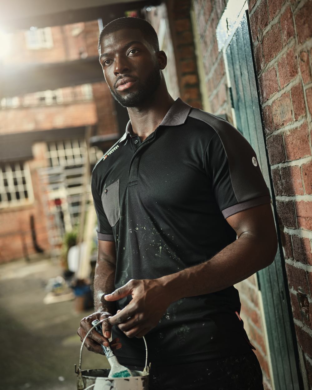 Black coloured Regatta Mens Offensive Moisture Wicking Polo Shirt on blurry background