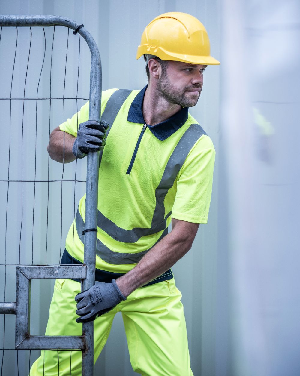 Yellow Navy coloured Regatta Professional Mens Hi Vis Pro Reflective Polo Work Shirt on outdoor background