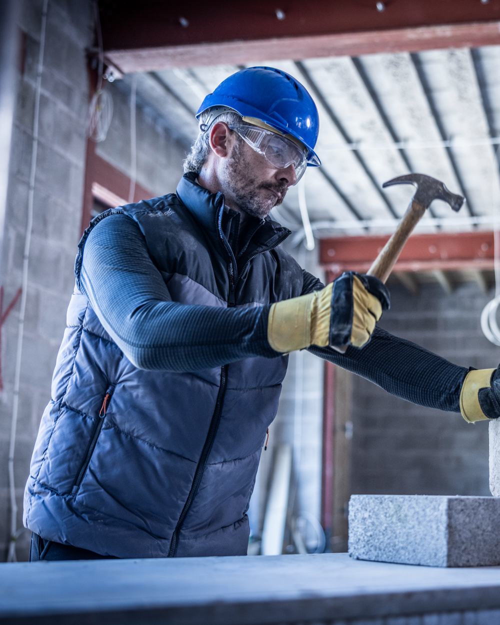 Iron Black coloured Regatta Professional Mens Regime Insulated Bodywarmer on factory background