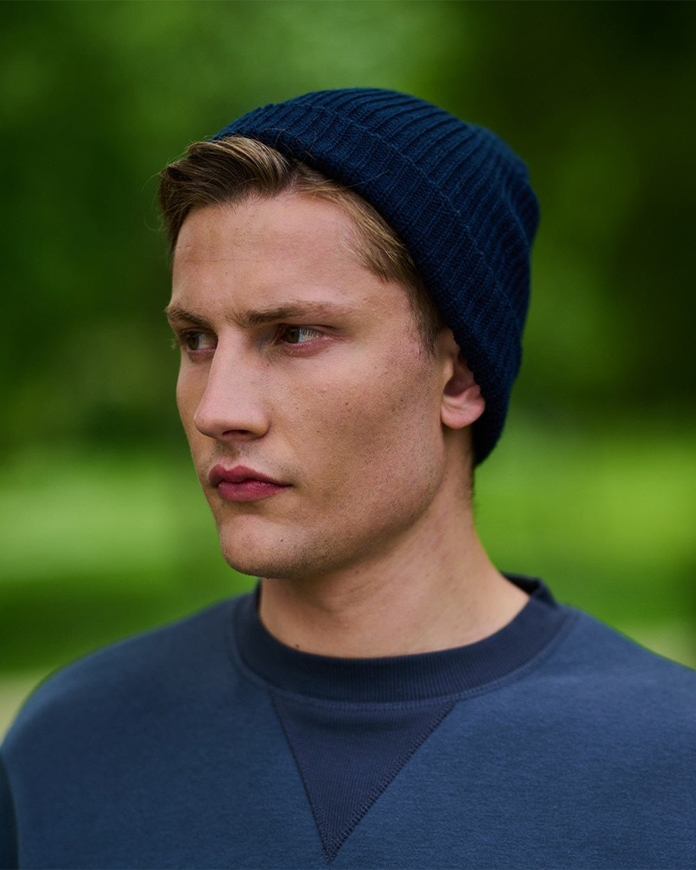 Navy coloured Regatta Watch Hat on blurry green background
