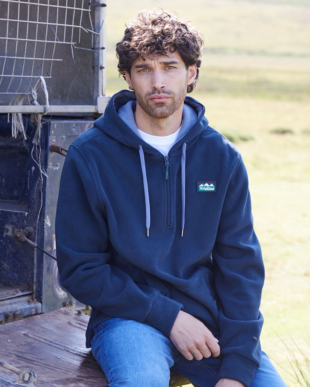 Navy coloured Ridgeline Ballistic Hooded Fleece on outdoor background