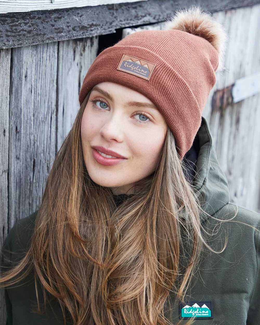 Nutmeg coloured Ridgeline Heritage Fine Knit Bobble Hat on outdoor background
