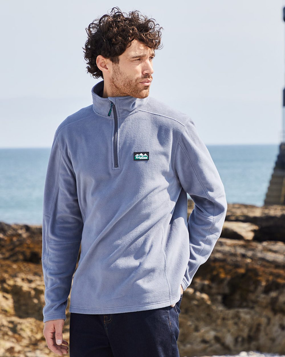 Storm coloured Ridgeline Narvik Fleece on sea background
