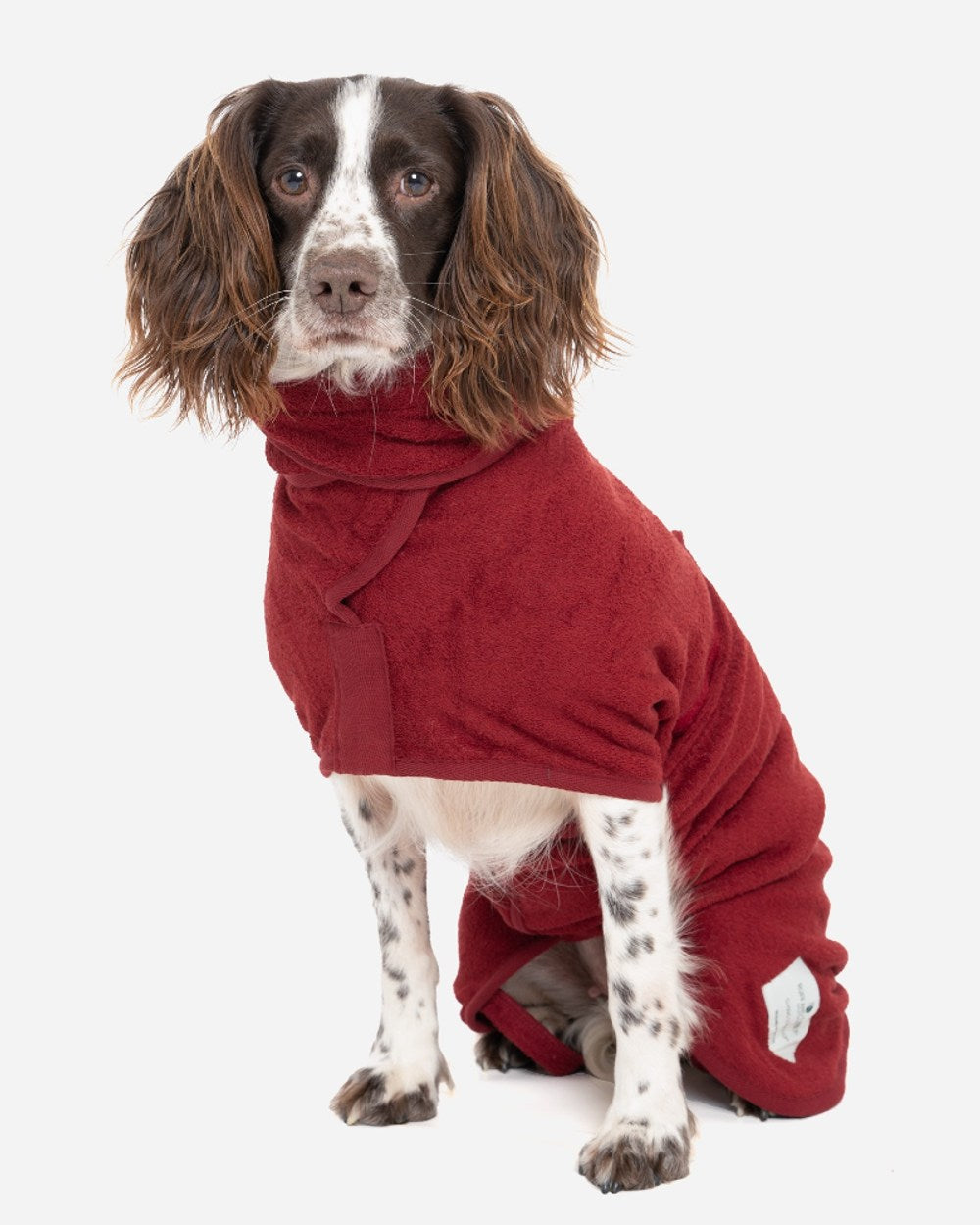 Rosehip coloured fleece dog coat on a white/grey background